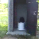 We are shown a heavily used outhouse in a park that is filled with turds and toilet paper from previous visitors. Next, we get to see a woman add her fresh one to the stinking pile.